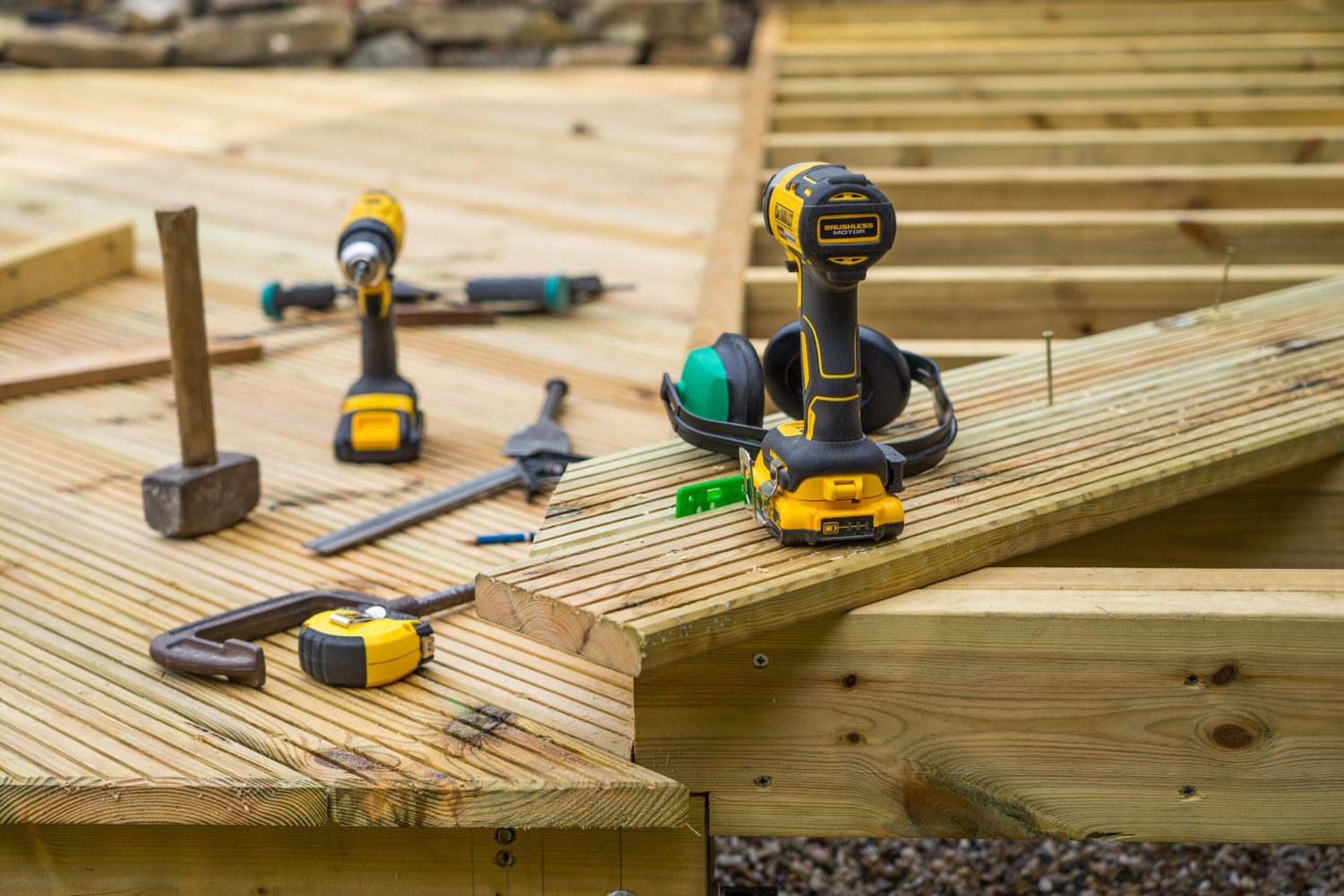 Image of joists, planks and tools on a low level deck being constructed